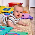 Kid baby boy plying with puzzle toy on floor Royalty Free Stock Photo