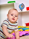 Kid baby boy plying with puzzle toy on floor Royalty Free Stock Photo