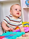 Kid baby boy plying with puzzle toy on floor Royalty Free Stock Photo