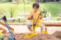 Kid baby boy todler playing construction truck toy diging sand in playground Royalty Free Stock Photo