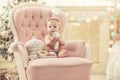 Kid baby girl in pink clothes and happy interior