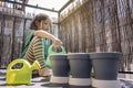 Kid at the balcony watering the plants