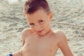 Kid on beach smiling looking at you camera gesture. Positive emotions, face expressions