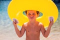 Kid on beach with swimming circle. Children and holiday concept Royalty Free Stock Photo