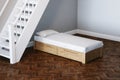 Kid bed design concept in new child room under wooden stairs 3d