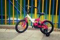 Kid bicycle next to colorful fence Royalty Free Stock Photo