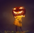 Kid with a big pumpkin head Royalty Free Stock Photo