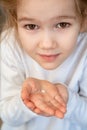 Kid blonde girl with fallen milk tooth in hand. Royalty Free Stock Photo