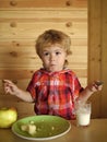 Kid or blonde happy boy eating apple. Royalty Free Stock Photo