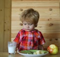 Kid or blonde happy boy eating apple. Royalty Free Stock Photo