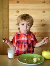 Kid or blonde happy boy eating apple. Royalty Free Stock Photo