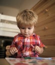 Kid or blonde happy boy paint with felt pen.