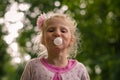 Kid blowing chewing gum bubbles Royalty Free Stock Photo