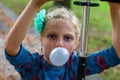 Kid blowing chewing gum bubbles Royalty Free Stock Photo