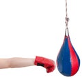 Kid with boxing glove punches punching bag Royalty Free Stock Photo