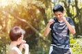 Kid boxing. young boy boxer practice muay Thai punches with father coach