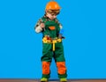 Kid boy in builders uniform and helmet with repair tools. Child game. Little boy plays construction worker.