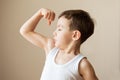 Kid boy child showing muscles fist strength training