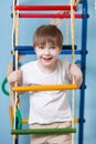 Kid boy climbing a rope ladder Royalty Free Stock Photo