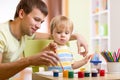 Kid boy and dad paint together Royalty Free Stock Photo