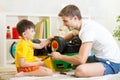 Kid boy and dad repair toy trunk Royalty Free Stock Photo