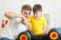 Kid boy and dad repair toy trunk Royalty Free Stock Photo