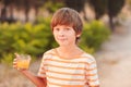 Kid boy drinking orange juice Royalty Free Stock Photo