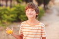 Kid boy drinking orange juice Royalty Free Stock Photo