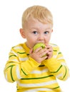 Kid boy eating green apple, isolated