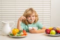 Kid boy eating healthy food vegetables. Breakfast with milk, fruits and vegetables. Child eating during lunch or dinner. Royalty Free Stock Photo