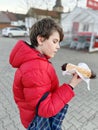 Kid boy eating sweet pie called Kreppel in German or rugelach sufganiyot. Child with cake, religious food for carnival