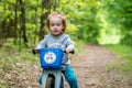 kid boy in forest with balance bike Royalty Free Stock Photo