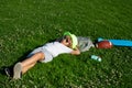 Kid boy girl resting on green grass. Child relax at the summer park. Kid boy lying on green grass outdoor. Royalty Free Stock Photo