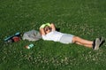 Kid boy girl resting on green grass. Happy children rest fun outdoors. Kids relaxing in spring park. Boy lying on green Royalty Free Stock Photo