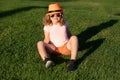 Kid boy girl resting on green grass. Kid boy relax at park outdoor. Summer weekend. Summertime vacation. Royalty Free Stock Photo