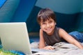 Kid, boy and happy with laptop in tent for camping, social media and online movie with portrait in nature. Person, face Royalty Free Stock Photo