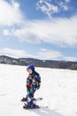 Kid boy in helmet, winter overalls skiing in the snowy mountains Royalty Free Stock Photo