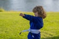 Kid boy in kimono practicing judo, taekwondo, jujitsu, kung-fu, jiu-jitsu, aikido outdoor. Sport karate kids. Little boy