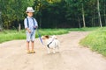 Kid boy learning how to tame and train a dog walk on leash Royalty Free Stock Photo