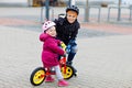 Kid boy and little toddler girl playing together outdoors. Brother in safety clothes skating with rollers. Happy sister Royalty Free Stock Photo