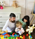 Kid boy, mother and father play builders in nursery Royalty Free Stock Photo