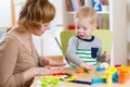 Kid boy and mother play colorful clay toy in nursery Royalty Free Stock Photo