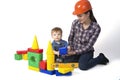 Kid boy and mother play together with construction set toy Royalty Free Stock Photo