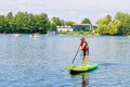 Kid boy paddling on sup board on a lake. Active child on modern trendy stand up paddle board. Summer outdoors vacations Royalty Free Stock Photo