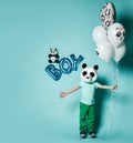 Kid boy in panda mask stands with balloons and hands spread for hugs. Translation from Russian on balloon: I love you Royalty Free Stock Photo