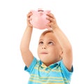 Kid, boy and piggy bank for change, money box and checking savings in studio by white background. Male person, child and