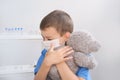Kid, boy playing doctor, hugging teddy bear tightly, face shield, health concept, disease treatment, coronavirus, COVID-19, life