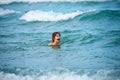 Kid boy playing and swimming in blue sea on summer. Blue ocean with wawes. Child boy swimming in sea. Royalty Free Stock Photo