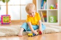 Kid boy playing with toys indoor Royalty Free Stock Photo