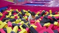 Kid boy in the pool of toy cubes in a game center